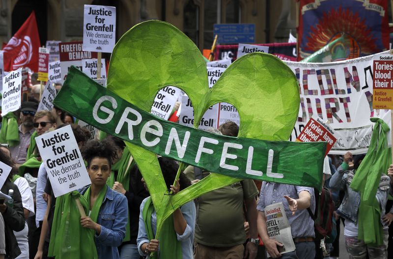 FILE _ Demonstrators march in the Grenfell fire one year anniversary solidarity march organized by Justice4Grenfell and the Fire Brigade's Union, in Westminster in London, Saturday, June 16, 2018. (AP Photo/Kirsty Wigglesworth, File)