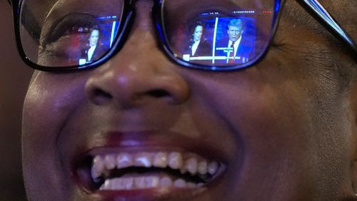 Sheena Carey laughs as she watches the presidential debate between Republican presidential nominee former President Donald Trump and Democratic presidential nominee Vice President Kamala Harris, Tuesday, Sept. 10, 2024, in Milwaukee. (AP Photo/Morry Gash)