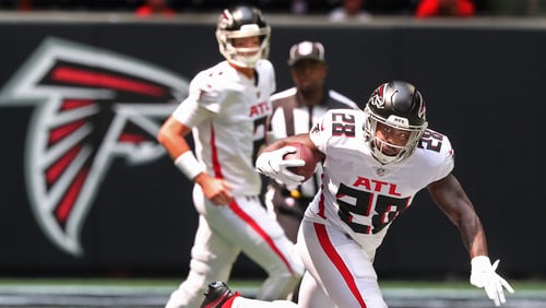 Falcons running back Mike Davis picks up a first down on the game's opening drive against the Philadelphia Eagles Sunday, Sept. 12, 2021, at Mercedes-Benz Stadium in Atlanta. (Curtis Compton / Curtis.Compton@ajc.com)