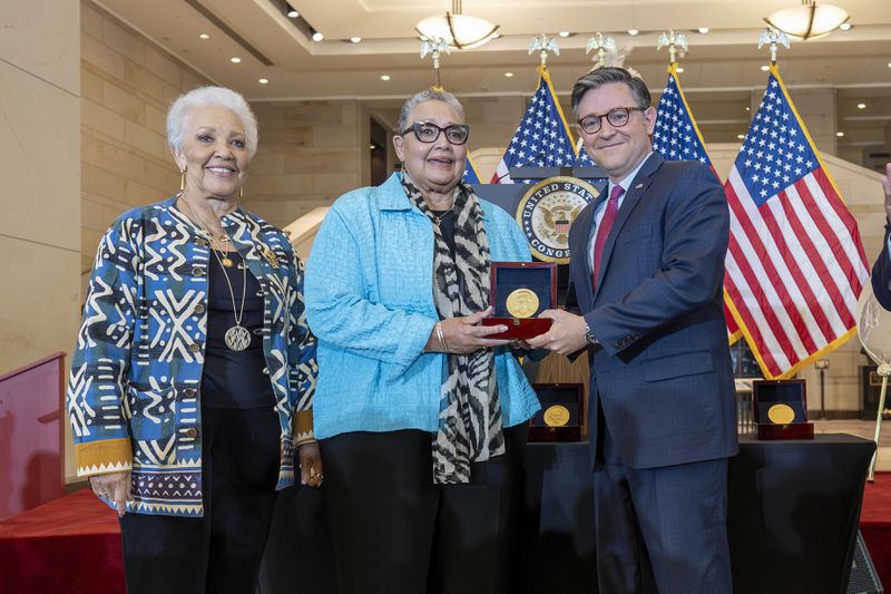 House Speaker Mike Johnson, R-La., center, presents a Congressional Gold Medal posthumously to Joylette Hylick, left, and Katherine Moore, daughters of Katherine Johnson, the Black NASA mathematician featured in the movie "Hidden Figures," at the Capitol in Washington, Wednesday, Sept. 18, 2024. (AP Photo/J. Scott Applewhite)