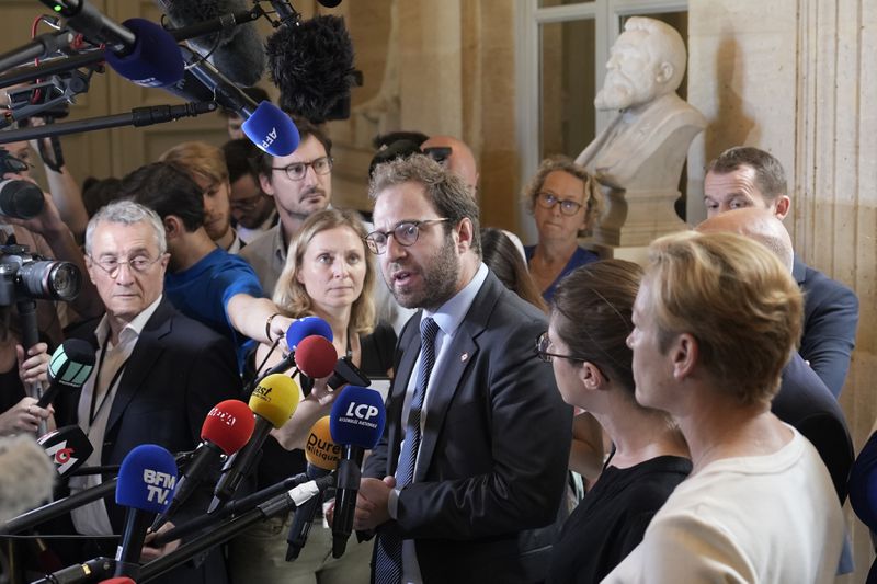 FILE - Antoine Armand, center, deputy for the French Alps Savoie region, speaks at the National Assembly, Thursday, June 8, 2023 in Paris. (AP Photo/Lewis Joly, File)