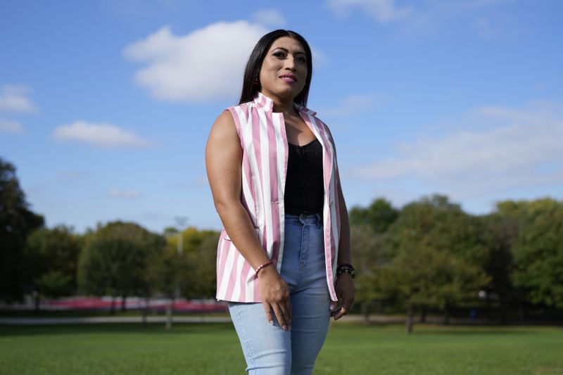 Julieth Luna Garcia, a transgender woman from El Salvador, poses for photos at Horner Park in Chicago, Monday, Sept. 30, 2024. (AP Photo/Nam Y. Huh)