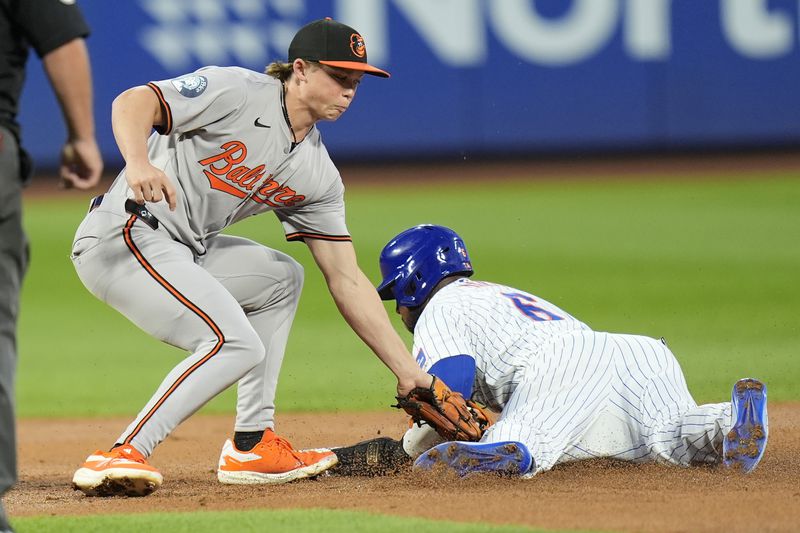 New York Mets' Starling Marte, right, steals second base in front of Baltimore Orioles second baseman Jackson Holliday during the first inning of a baseball game at Citi Field, Monday, Aug. 19, 2024, in New York. (AP Photo/Seth Wenig)