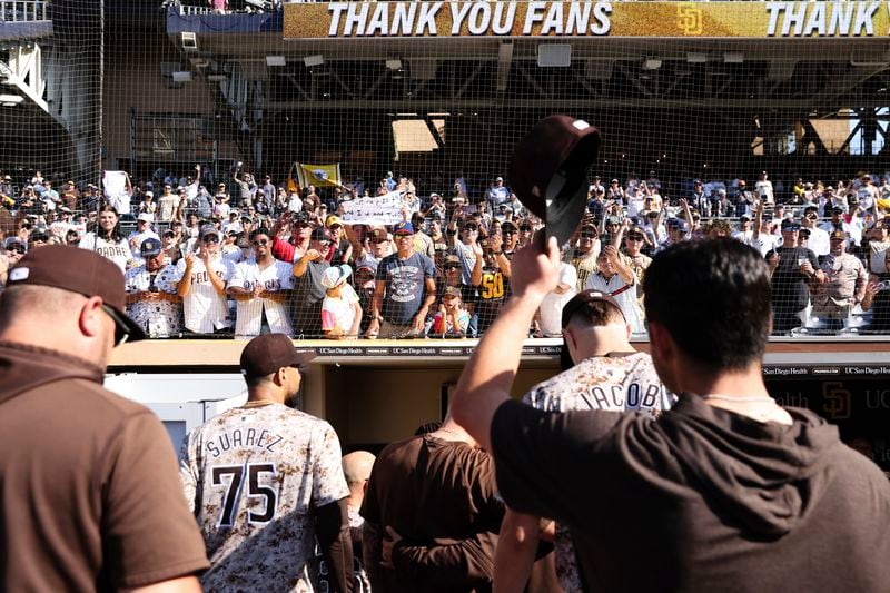 Fans cheer for the Padres as they leave the field following a victory over the Chicago White Sox in a baseball game Sunday, Sept. 22, 2024, in San Diego. (AP Photo/Derrick Tuskan)