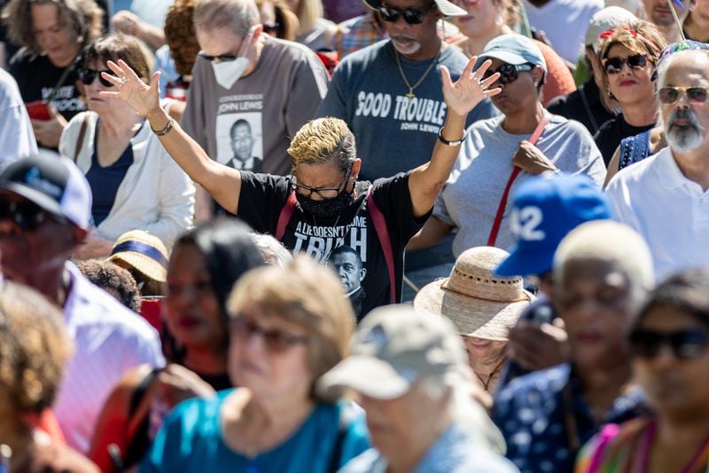 The crowd reacts to the invocation from Rev Dr. Jamal Bryant during the statue unveiling ceremony memorial honoring the late Congressman John Lewis in Decatur on Saturday, Aug 24, 2024. (Steve Schaefer / AJC)