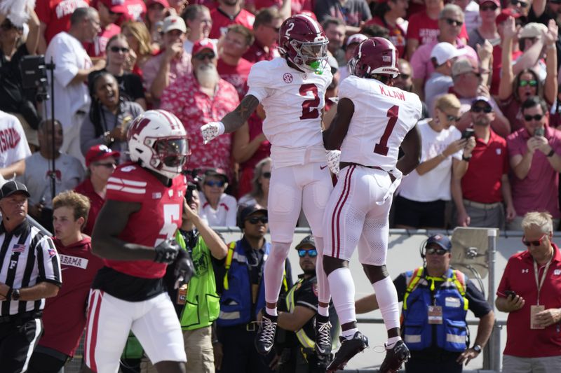 Alabama's Ryan Williams (2) celebrates his touchdown catch with Kendrick Law (1) during the first half of an NCAA college football game against Wisconsin Saturday, Sept. 14, 2024, in Madison, Wis. (AP Photo/Morry Gash)