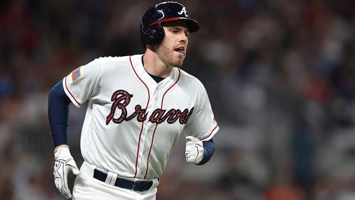 Atlanta Braves third baseman Freddie Freeman runs to first base during the fourth inning against the Houston Astros, Tuesday, July 4, 2017, in Atlanta. (AP Photo/Richard Hamm)