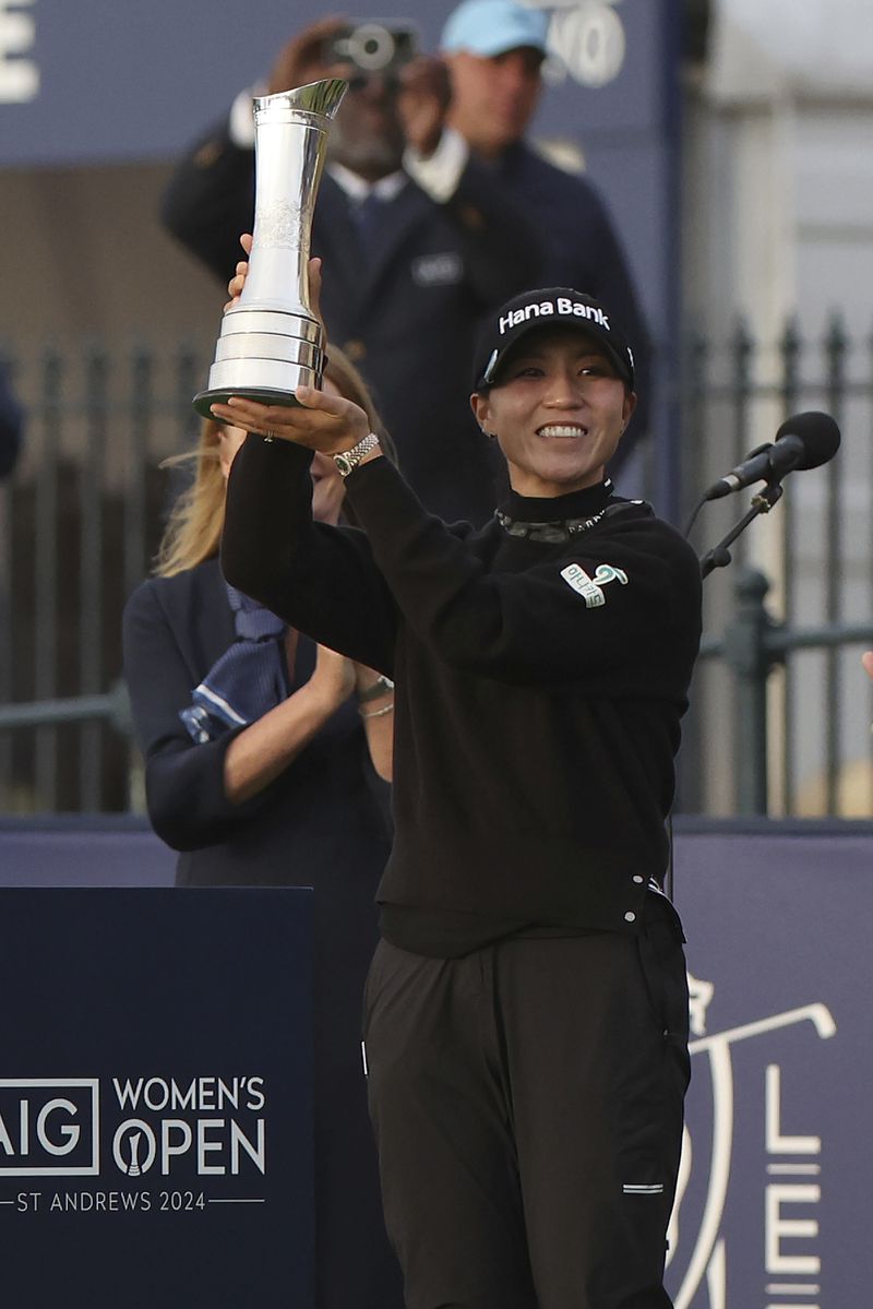 Lydia Ko, of New Zealand, holds up the trophy as Champion golfer after winning the Women's British Open golf championship, in St. Andrews, Scotland, Sunday, Aug. 25, 2024. (AP Photo/Scott Heppell)