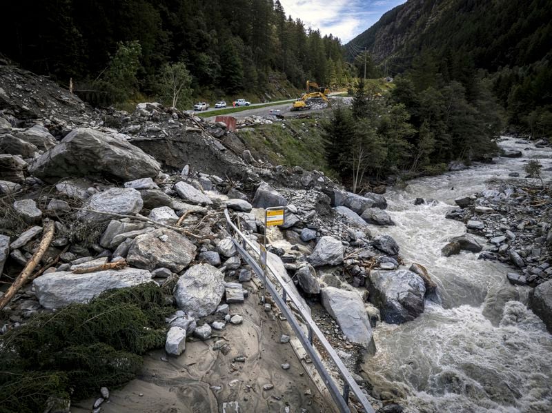 A road is blocked in Eisten, Switzerland, Friday, Sept. 5, 2024, after a landslide following severe weather. (Andrea Soltermann/Keystone via AP)