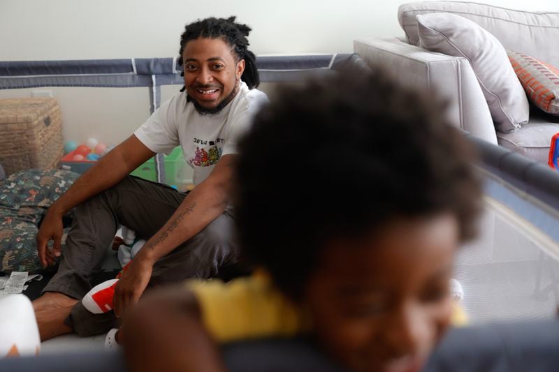 Atlanta rapper Deante Hitchcock plays with his son Otto, 1, at his home in Decatur on Monday, May 1, 2023.  (Natrice Miller/natrice.miller@ajc.com)