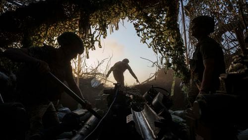 Ukrainian servicemen of 148th separate artillery brigade of the Air Assault Forces prepare M777 howitzer to fire towards Russian positions at the frontline in Donetsk region, Ukraine, Wednesday, August 21, 2024. (AP Photo/Evgeniy Maloletka)