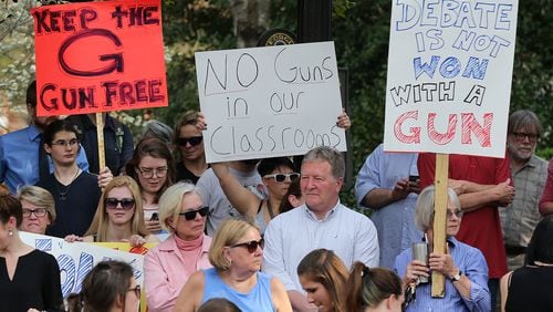 University of Georgia students, faculty, staff and local residents protest at the university in 2017 to oppose campus gun legislation the state Legislature approved that year. Curtis Compton/ccompton@ajc.com