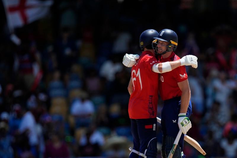 England's captain Jos Buttler, right, and batting partner Phil Salt celebrate after their win in the ICC Men's T20 World Cup cricket match between the United States and England at Kensington Oval in Bridgetown, Barbados, Sunday, June 23, 2024. (AP Photo/Ricardo Mazalan)