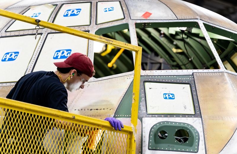 An employee works on a C-130J cargo aircraft at Lockheed Martin's manufacturing facility in Marietta on Thursday, Aug. 22. (Seeger Gray/AJC)