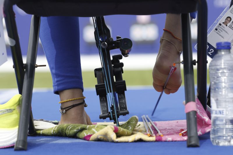 Archer Sheetal Devi from India prepares to place an arrow during the Paralympic Games in Paris on Thursday, Aug. 29, 2024. (AP Photo/Felix Scheyer)