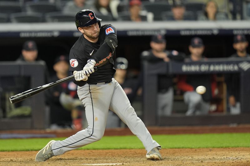 Cleveland Guardians' David Fry hits a three-run triple during the 12th inning of a baseball game against the New York Yankees at Yankee Stadium Tuesday, Aug. 20, 2024, in New York. (AP Photo/Seth Wenig)