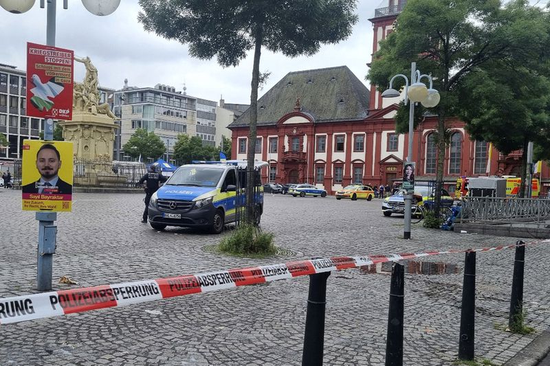 The area is cordoned off as police and firefighters are deployed following an incident on Mannheim's market square, Germany, Friday, May 31, 2024. An assailant with a knife attacked and wounded several people in a square in the southwestern German city of Mannheim on Friday, police said. Police shot at the attacker, who also was hurt. (Rene Priebe/dpa via AP)