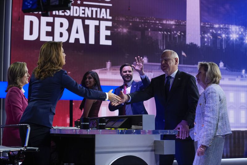 Republican vice presidential nominee Sen. JD Vance, R-Ohio, and his wife Usha Vance leave that stage as Democratic vice presidential candidate Minnesota Gov. Tim Walz and his wife Gwen Walz greet moderators Norah O'Donnell and Margaret Brennan after a vice presidential debate hosted by CBS News, Tuesday, Oct. 1, 2024, in New York. (AP Photo/Matt Rourke)