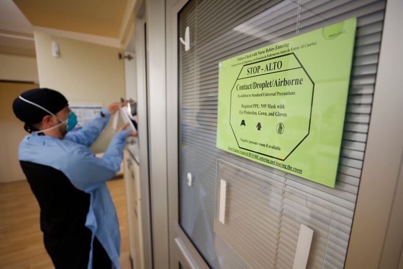 A sign warns medical staff and visitors to take precautions before entering rooms with patients infected with COVID-19 at Northeast Medical Georgia Center in Gainesville, GA, on Monday, February 5, 2024. (Miguel Martinez/The Atlanta Journal-Constitution/TNS)