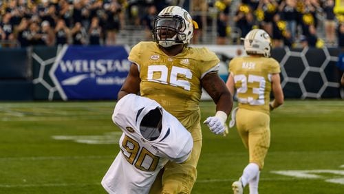 At Georgia Tech's spring game April 26, defensive tackle Chris Martin carried the jersey and shoulder pads of the late Brandon Adams onto the field at Bobby Dodd Stadium. (Danny Karnik/Georgia Tech Athletics)