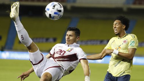 Venezuela's Ronald Hernandez (left) and Colombia's Johan Mojica battle for the ball during a qualifying soccer match for the FIFA World Cup Qatar 2022 Friday, Oct. 9, 2020, in Barranquilla, Colombia. (Mauricio Dueñas/AP)