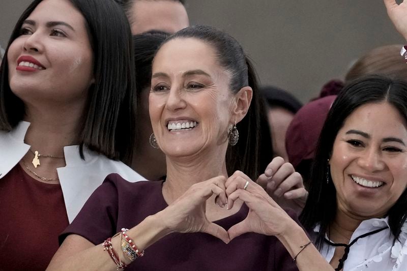 FILE - Presidential candidate Claudia Sheinbaum flashes a hand-heart sign during her closing campaign rally at the Zocalo in Mexico City, May 29, 2024. Sheinbaum, a climate scientist and former Mexico City mayor, will be sworn in as Mexico’s first woman president on Oct. 1. (AP Photo/Eduardo Verdugo, File)