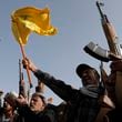 Houthi supporters raise a Hezbollah flag during an anti-Israel and anti-U.S. rally in Sanaa, Yemen, Friday, Sept. 27, 2024. (AP Photo/Osamah Abdulrahman)