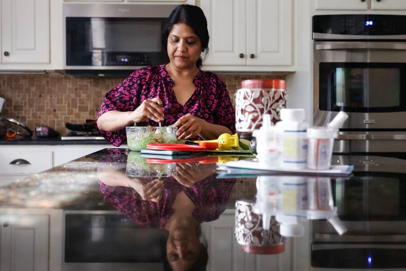 Sowmya Siragowni prepares dinner at her home in Alpharetta on Wednesday, Oct. 25, 2023. Siragowni, a hospitalist at Emory Saint Joseph’s hospital, was diagnosed with stage 4 ovarian cancer five years ago. (Natrice Miller/ Natrice.miller@ajc.com)