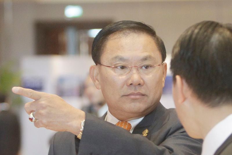 FILE- Cambodian business tycoon Ly Yong Phat, left, talks his staff member at the Cambodia-China Business and Investment Forum at the outskirt of Phnom Penh, Cambodia, Thursday, Dec. 1, 2016. (AP Photo/Heng Sinith)