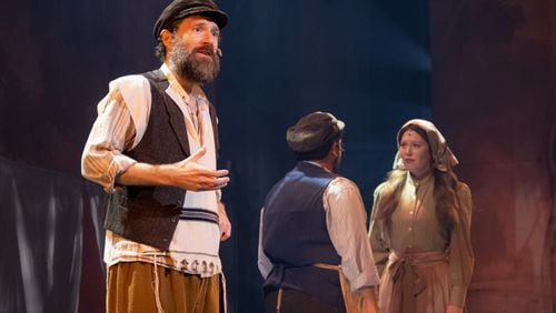 From left, the poor dairyman Tevye (Jacob Fishel) struggles with a changing world, as Motel (Brian Wittenberg) and Tevye's daughter Tzeitel (Carly Ann Lovell) fall in love in "Fiddler on the Roof." Photo: Mason Wood