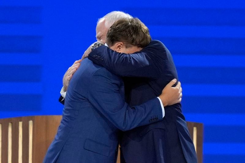 Democratic vice presidential nominee Minnesota Gov. Tim Walz, right, hugs his son Gus Walz after speaking during the Democratic National Convention Wednesday, Aug. 21, 2024, in Chicago. (AP Photo/J. Scott Applewhite)