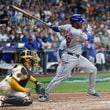 New York Mets' J.D. Martinez hits a two-run scoring single during the fifth inning of Game 2 of a National League wild card baseball game against the Milwaukee Brewers Tuesday, Oct. 1, 2024, in Milwaukee. (AP Photo/Morry Gash)