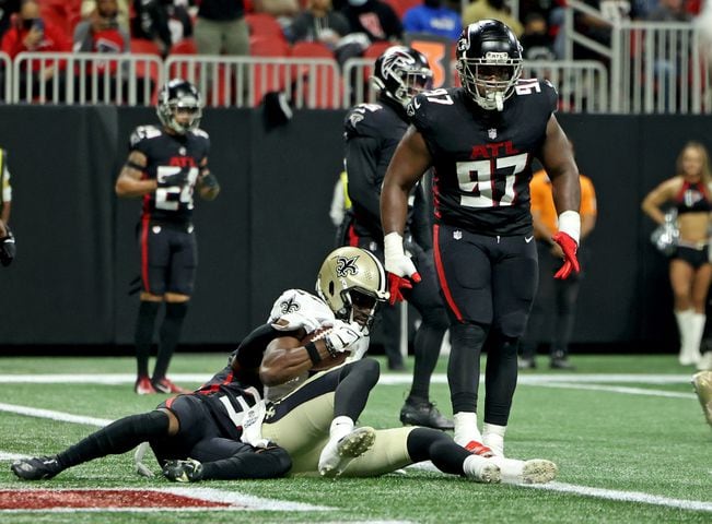 Saints tight end Juwan Johnson (83) scores a touchdown as Falcons defensive end Grady Jarrett (97) is shown on the play late during the second quarter. Johnson's score put the Saints up 24-6 at halftime.  (JASON GETZ FOR THE ATLANTA JOURNAL-CONSTITUTION)