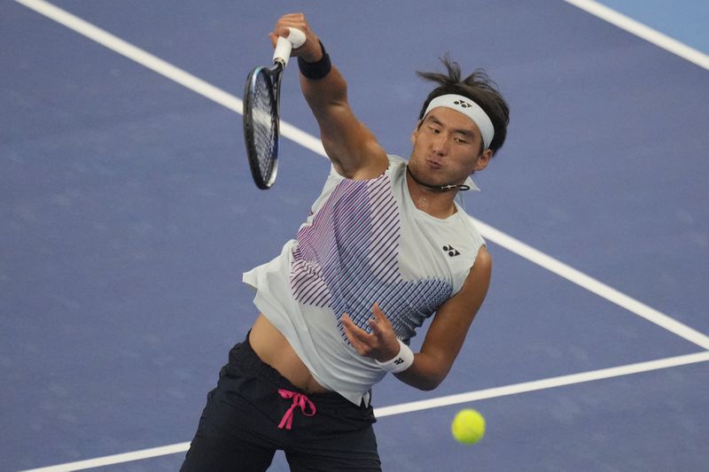 China's Bu Yunchaokete returns the ball during the China Open tennis tournament men's singles semi-final match against Italy's Jannik Sinner, at the National Tennis Center in Beijing, Tuesday, Oct. 1, 2024.(AP Photo/Achmad Ibrahim)