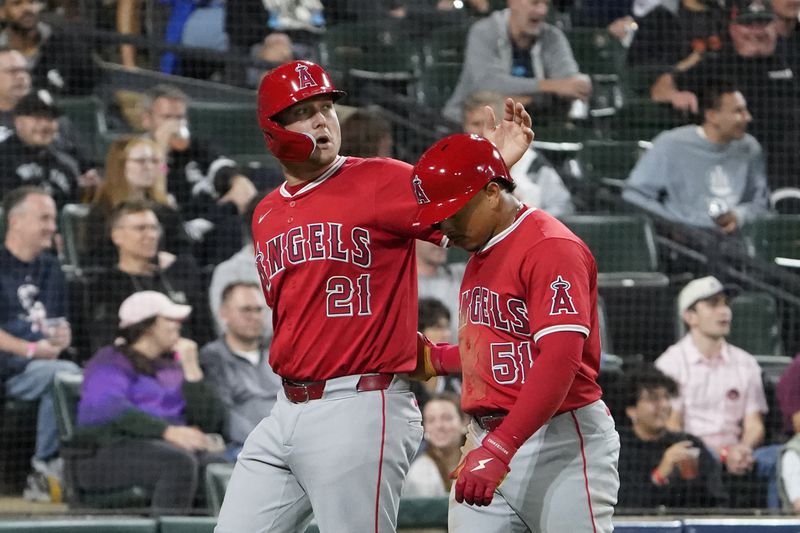 Los Angeles Angels' Matt Thaiss (21) and Gustavo Campero (51) react after scoring against the Chicago White Sox during fourth inning of a baseball game, Wednesday, Sept. 25, 2024, in Chicago. (AP Photo/David Banks)