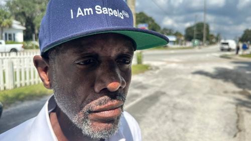 Jazz Watts, a resident of Sapelo Island, wears a hat that reads "I am Sapelo" outside the McIntosh County courthouse in Darien, Ga., on Friday, Sept. 20, 2024. (AP Photo/Russ Bynum)