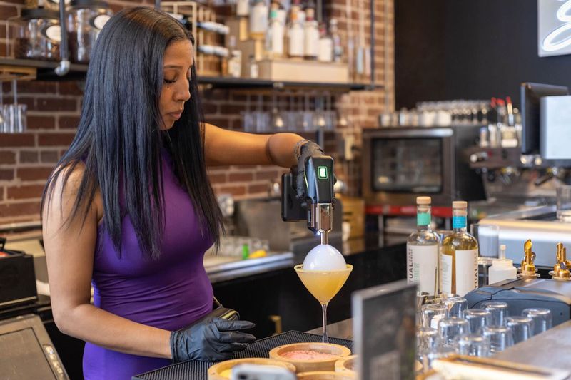 Aja Wolfe, the owner of Sober Social in Castleberry Hill, mixes a non-alcoholic drink behind the bar. / Courtesy of Aja Wolfe