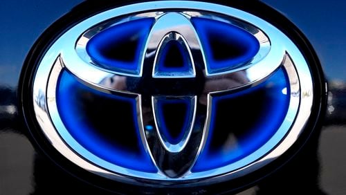 FILE - Toyota logo (Hybrid model) is seen at a new and used vehicles dealership in Palatine, Ill., Tuesday, March 20, 2024. Toyota reported Thursday, Aug. 1, that its April-June profit rose 1.7%, boosted by a favorable exchange rate, as vehicle sales grew around the world despite a certification scandal that halted production in Japan for several months. (AP Photo/Nam Y. Huh, File)