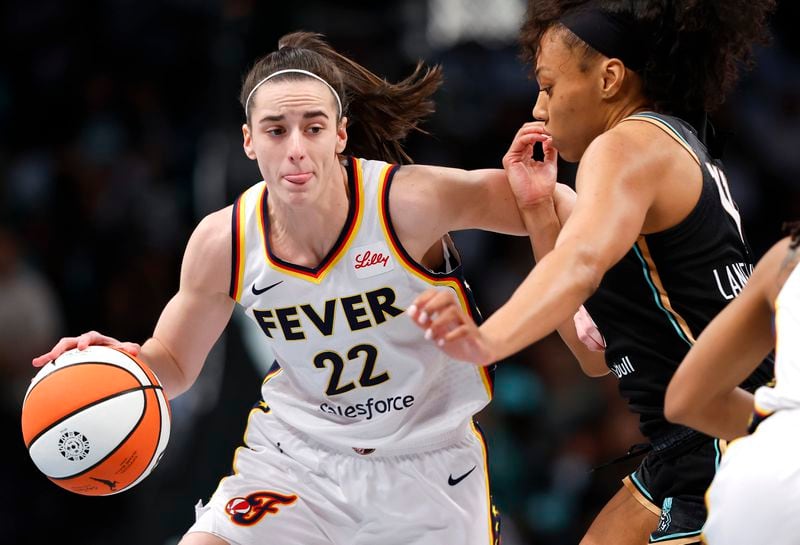 FILE - Indiana Fever guard Caitlin Clark (22) drives to the basket against New York Liberty forward Betnijah Laney-Hamilton (44) during the first half of a WNBA basketball game, Saturday, May 18, 2024, in New York. (AP Photo/Noah K. Murray, File)