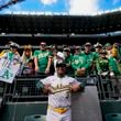 Oakland Athletics third base coach Eric Martins (3) poses with fans before a baseball game against the Seattle Mariners, Sunday, Sept. 29, 2024, in Seattle. (AP Photo/Lindsey Wasson)