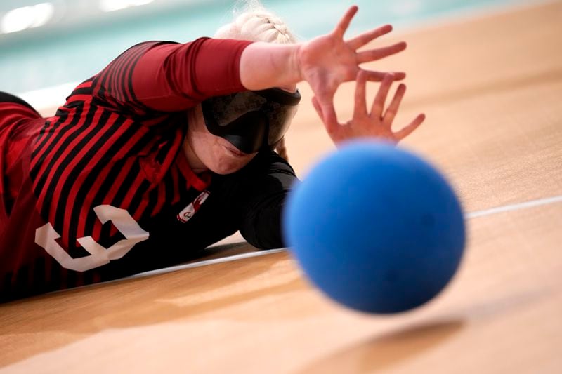 Whitney Bogart dives to catch the ball during during the Women's preliminary round Goalball game against France at the 2024 Paralympics, Thursday, Aug. 29, 2024, in Paris, France. (AP Photo/Christophe Ena)