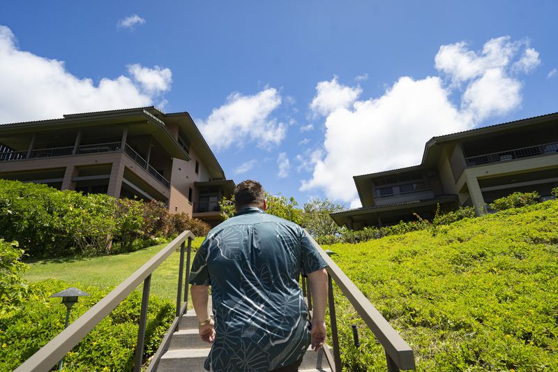 Jeremy Stice, who manages more than 40 vacation rental properties, walks around The Ridge Villas on Monday, June 24, 2024, in Lahaina, Hawaii. The Ridge Villas with 142 units for short-term rental is part of the 101 properties that the County of Maui may begin phasing out as early as 2025. (AP Photo/Mengshin Lin)