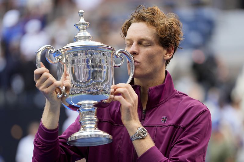 Jannik Sinner, of Italy, kisses the championship trophy after defeating Taylor Fritz, of the United States, in the men's singles final of the U.S. Open tennis championships, Sunday, Sept. 8, 2024, in New York. (AP Photo/Julia Nikhinson)