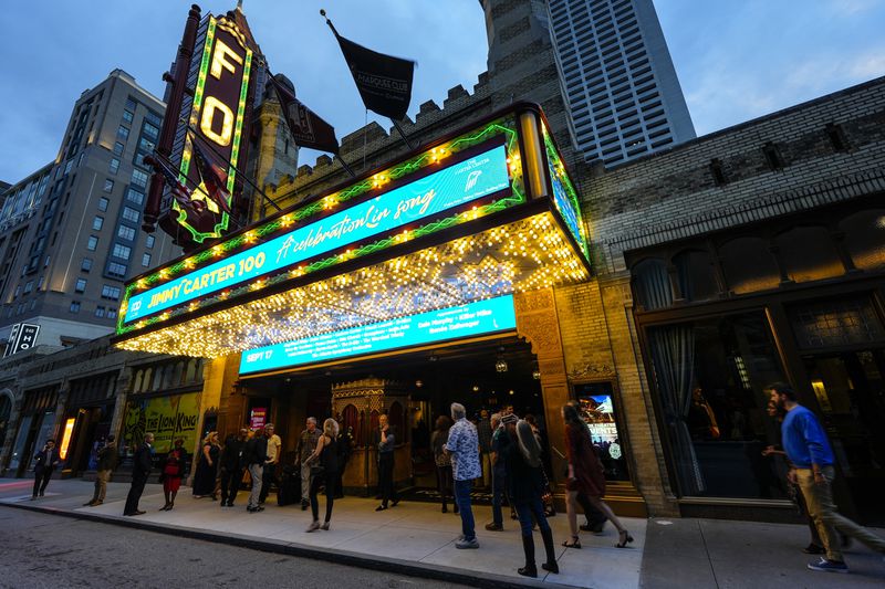 People wait in line ahead of a "Jimmy Carter 100: A Celebration in Song," concert at the Fox Theatre, Tuesday, Sept. 17, 2024, in Atlanta. Former President Carter turns 100-years old on Oct. 1. (AP Photo/Mike Stewart)