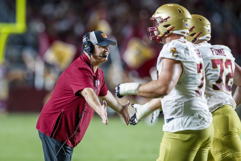 Boston College head coach Bill O'Brien congratulates players after his team scored their second touchdown against Florida State during the first half of an NCAA college football game, Monday, Sept. 2, 2024, in Tallahassee, Fla. (AP Photo/Colin Hackley)