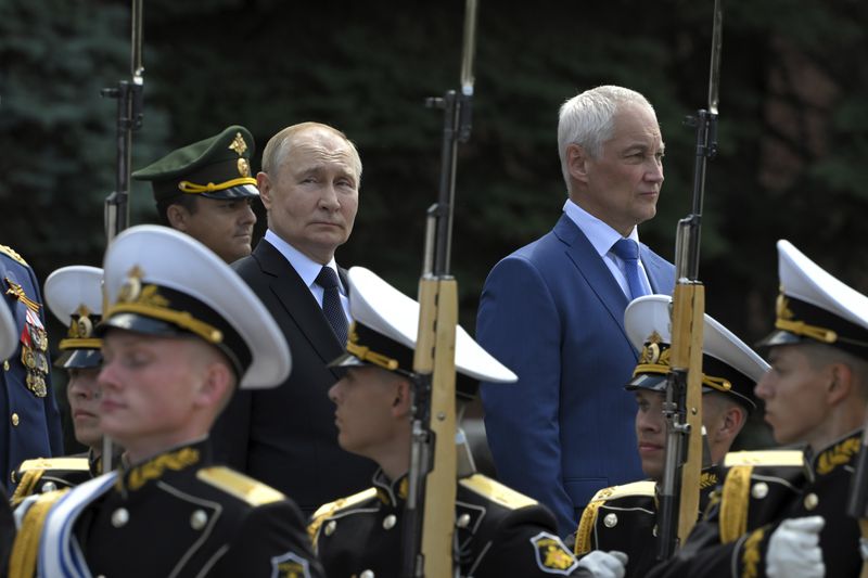 FILE - Russian President Vladimir Putin, background center, and Defense Minister Andrei Belousov, background right, attend a ceremony at the Tomb of Unknown Soldier in Moscow, on Saturday, June 22, 2024. Putin says that Moscow isn't seeking quick gains in Ukraine and will stick to the current strategy of slow advances as it presses a grinding summer offensive. (Sergei Guneyev, Sputnik, Kremlin Pool Photo via AP, File)