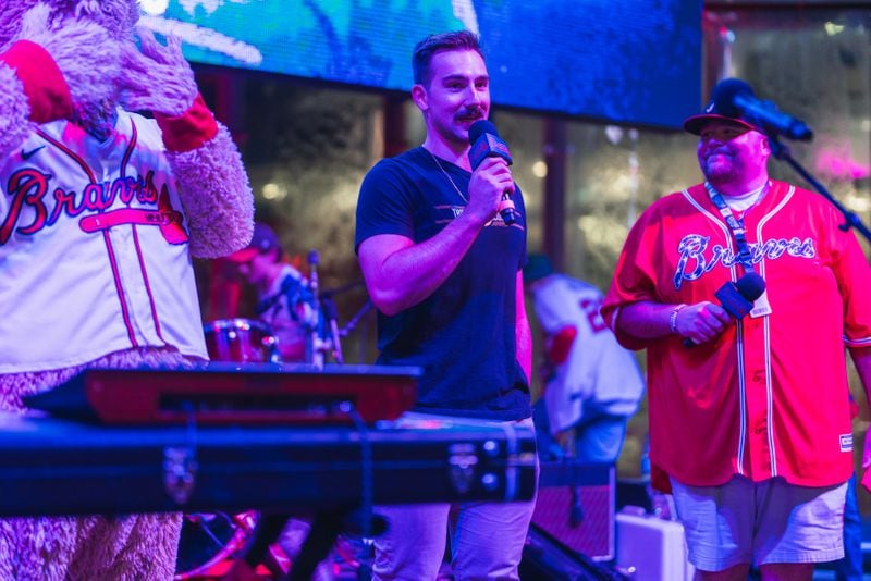 Atlanta Braves pitcher Spencer Strider (center), who spearheaded a vinyl giveaway spotlighting three indie bands, introduces one of them at a post-game concert on Aug. 7. (Lyndon Terrell/Atlanta Braves)