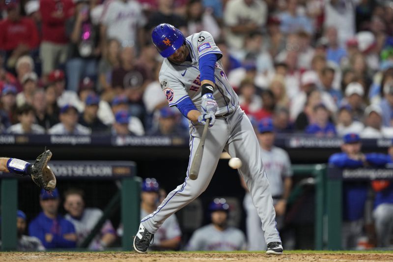 New York Mets' J.D. Martinez hits an RBI single off Philadelphia Phillies pitcher Orion Kerkering during the eighth inning of Game 1 of a baseball NL Division Series, Saturday, Oct. 5, 2024, in Philadelphia. (AP Photo/Matt Slocum)