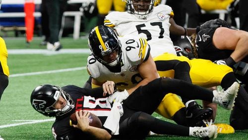 Atlanta Falcons quarterback Kirk Cousins (18) gets a sack in the game’s last play by Pittsburgh Steelers linebacker T.J. Watt (90) on Sunday, Sept. 8, at Mercedes-Benz Stadium in Atlanta. The Falcons lost 18-10. (Miguel Martinez/ AJC)