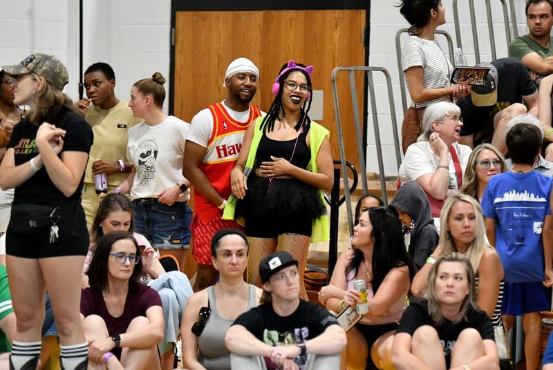 Jessika Morgan (center), a.k.a. "Jork the Dork," reacts as she watches during Atlanta Roller Derby game at Agnes Scott College’s Woodruff Athletic Complex, Saturday, June 8, 2024, in Decatur. (Hyosub Shin / AJC)